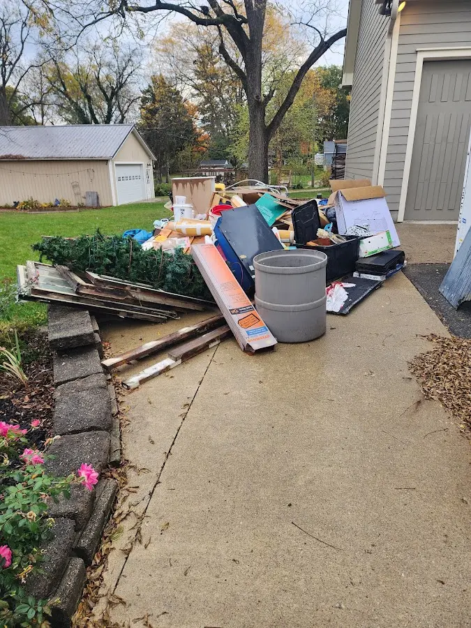 Dumpster being loaded with debris for Estate Cleanout Dumpster Rental in Bay St. Louis